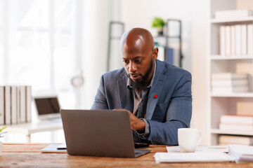 Wall Mural - Businessman working at office with documents on his desk, doing planning analyzing the financial report, African American business plan investment, finance analysis concept