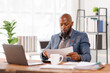 © David - African American business man Accounting using calculating income-expenditure and analyzing real estate investment data report Financial and tax systems concept.