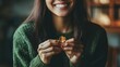© Seak - A person holding a lucky charm, smiling with a sense of good fortune.'