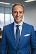 © haiqiang - smiling man in blue suit and tie standing in an office