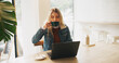 © peopleimages.com - Woman, laptop and drink with remote work at cafe with review, freelance or report for copywriting job. Person, computer and editor with coffee cup for project, proposal or start morning at restaurant