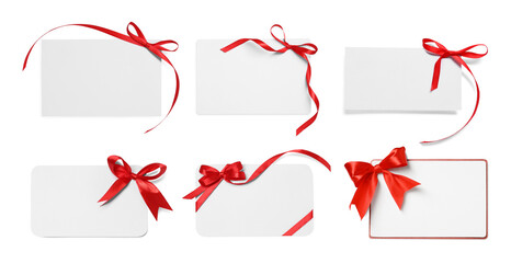 Wall Mural - Blank cards with red bows isolated on white, top view