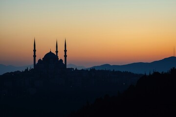Wall Mural - mosque silhouette at sunset over cityscape hills