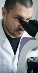 Wall Mural - dedicated researcher concentrating on detailed microscopic analysis within wellequipped laboratory e