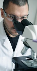 Wall Mural - dedicated researcher concentrating on detailed microscopic analysis within wellequipped laboratory e