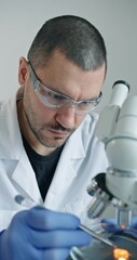 Wall Mural - dedicated researcher concentrating on detailed microscopic analysis within wellequipped laboratory e