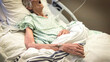 © Louis-Paul Photo - Portrait of senior woman sick lying in hospital bed, getting treatment