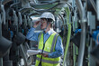 © ENGINEER - STUDIO - mechanic at work. Male engineer inspects and controls the cooling system of a large factory air conditioner.