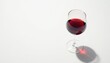 © retirementfun - Rich red wine glass filled with dark liquid on white surface, shadow, dinner, white background