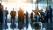 © Inspire Shots Hub - Close-up of a golden star trophy on a table in an office, with blurred business people in the background, symbolizing success, achievement, and recognition in the workplace.