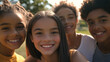 © mahamad - Close-up of preteen friends smiling in a park.