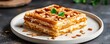 © Watcharaphon - International waffle day with celebration and recipe idea. Delicious layered waffle with nuts and mint garnish.