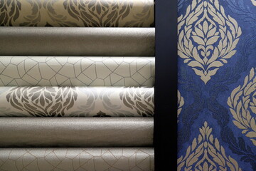 Wallpaper for the wall. Rolled up rolls of expensive, high quality vinyl wallpaper. Various textures, colors, backgrounds. Finishing materials for room, interior.