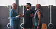 © peopleimages.com - Mature men, personal trainer and friends in gym for exercise, workout or training discussion. Physical therapy, support and help with routine with fitness, planning and wellness for retirement health