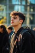 © Luisa - Young man with backpack, looking upward and forward, possibly contemplating his next steps in life or daydreaming about an upcoming adventure.