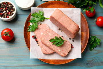 Wall Mural - Pieces of tasty canned meat, parsley, spices and tomatoes on light blue wooden table, flat lay