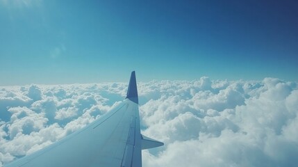 Poster - Soaring above fluffy clouds with a clear blue sky visible through the airplane window on a bright day. Generative AI