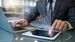© Media Srock - Businessman Analyzing Financial Growth on Tablet and Laptop