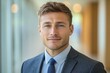 © c80 - Professional man in a formal suit smiling confidently in a modern office environment during daylight hours
