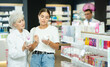 © JackF - Interested young girl asking old female pharmacist for advice concerning intimate hygiene product in chemist's shop