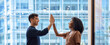 © insta_photos - Happy diverse business team man and woman giving high five at work in office. Two partners employees celebrating professional corporate success leadership financial work achievement in office. Banner