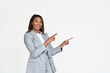 © insta_photos - Happy African American professional business woman ceo executive wearing suit pointing fingers aside isolated on white. Smiling businesswoman manager looking at camera advertising business service.