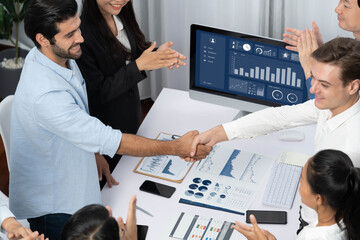 Fototapete - Diverse group of office employee worker shake hand after making agreement on strategic business marketing meeting. Teamwork and positive attitude create productive and supportive workplace. Prudent