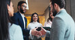© peopleimages.com - Smile, business people and shaking hands in office for greeting, b2b partnership or meeting. Handshake, cooperation and team introduction, welcome and hello at seminar hallway in hotel lobby at night