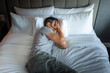 © kieferpix - Man lying in bed feeling stressed, tired, unhappy