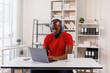 © David - African American freelancer business man wearing headphones, enjoying working on laptop at workplace office.