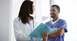 © peopleimages.com - Healthcare, doctors and paper in hospital for discussion, patient folder or medicine schedule. Woman, man nurse and document in clinic for medical report, information results and surgery feedback