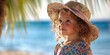 © Andrei - a little curly-haired girl in a straw hat and a flowered dress in close-up against the background of the blue sea and palm trees