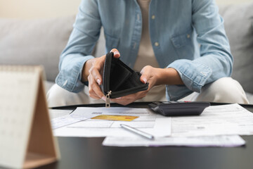 Wall Mural - Debt financial concept, stressed problem asian woman hand open empty wallet, purse not have budget of money to pay no have credit card, not able payment bill, loan or expense with bank, bankruptcy.