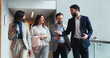 © HockleyM3/peopleimages.com - Discussion, walking or business people in lobby for project, group schedule or conference hall advice. Staff, teamwork or keynote speaker with smile in meeting for networking, seminar or event review