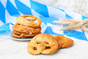 Wall Mural - Plate with soft pretzels and flag of Bavaria on white background