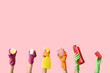 © Pixel-Shot - Female hands in rubber gloves holding bottles of detergent, jar with cleaning agent and sponges on pink background