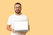© Pixel-Shot - Young man with blank laptop on orange background