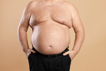 Wall Mural - Man with excessive belly fat on beige background, closeup. Overweight problem