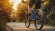 © diracreativa - Cyclist Riding Mountain Bike on Asphalt Road at Sunset
