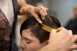 © alvaro - Hairdresser combing wet hair of young woman in salon