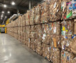 © CaptureCollabStudios - Large bales of recycled paper stacked in a processing facility for sorting and repurposing