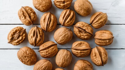 Poster - Walnuts spread evenly on a white wooden surface with a natural rustic texture showcasing their brown shells in a warm inviting arrangement