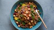 © Gular - Vibrant vegan soba noodle salad with chickpeas, peanuts, and herbs in a teal bowl, garnished with colorful beans and garnishes on a gray surface