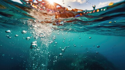 Aufkleber - Bubbles rising through clear turquoise water with sunlight creating a shimmering effect on the surface above, showcasing a tranquil ocean scene.