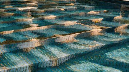 Aufkleber - Textured gold reflections on rippling turquoise water surface in a swimming pool creating a serene and peaceful atmosphere.
