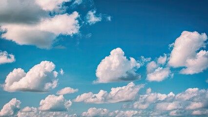 Poster - Blue sky with fluffy white clouds scattered across the upper two-thirds of the image creating a serene and peaceful atmosphere.