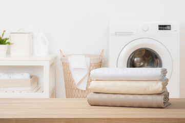 Wall Mural - stack of clean folded textile duvet covers on blurred laundry room background