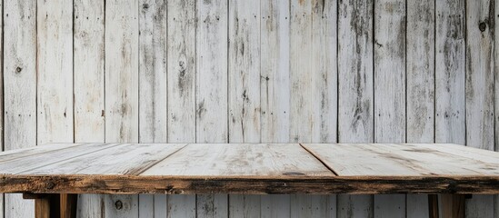 Wall Mural - Rustic wooden table in front of a whitewashed wooden wall featuring weathered textures and natural tones evoking a warm inviting atmosphere