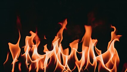 Poster - Vibrant orange and yellow fire flames rising against a solid black background creating a dynamic and intense visual contrast for dramatic effect