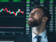 © CreativeIMGIdeas - Market Volatility: A pensive businessman gazes intently at a fluctuating stock market graph, reflecting the uncertainty and pressure inherent in the financial world.